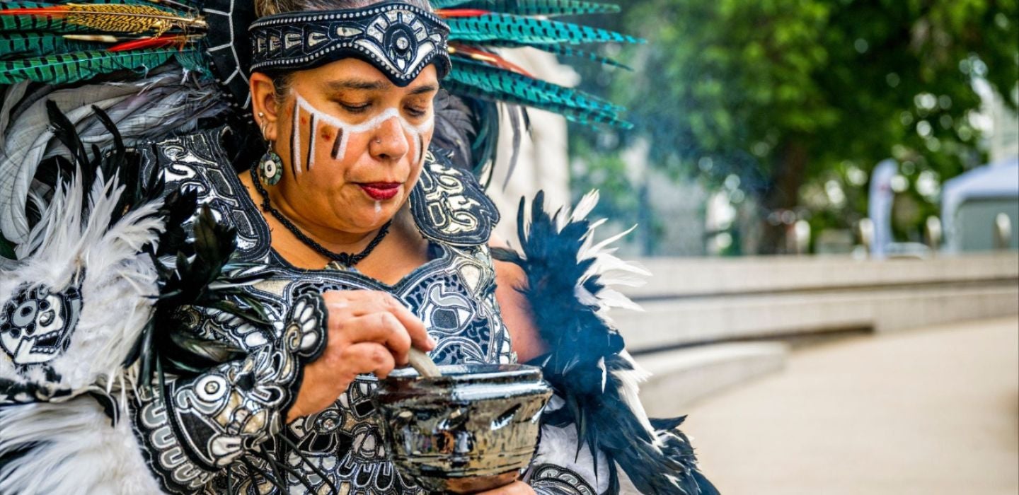 A dancer from Grupo Tlaloc Danza Azteca performs outside the McNichols Building for áyA Con, photo by Jonathan Phillips 1440x700